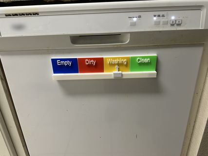 The magnet on the dishwasher door, below the control panel, the arrow at Washing.