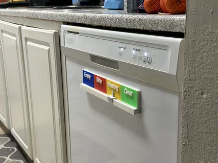 Farther back: the magnet on the dishwasher, between the kitchen cabinets.